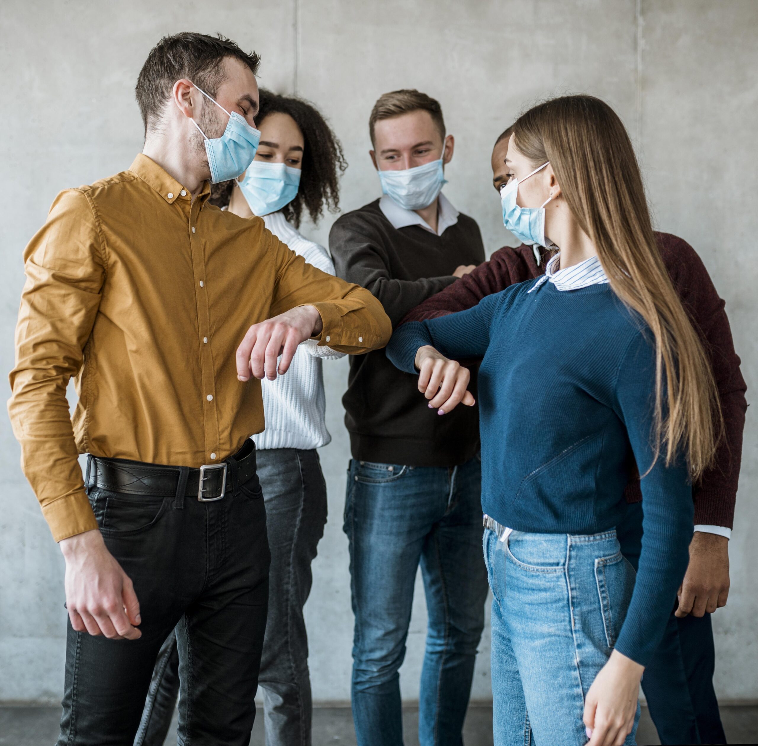 colleagues-with-medical-masks-doing-elbow-salute-meeting