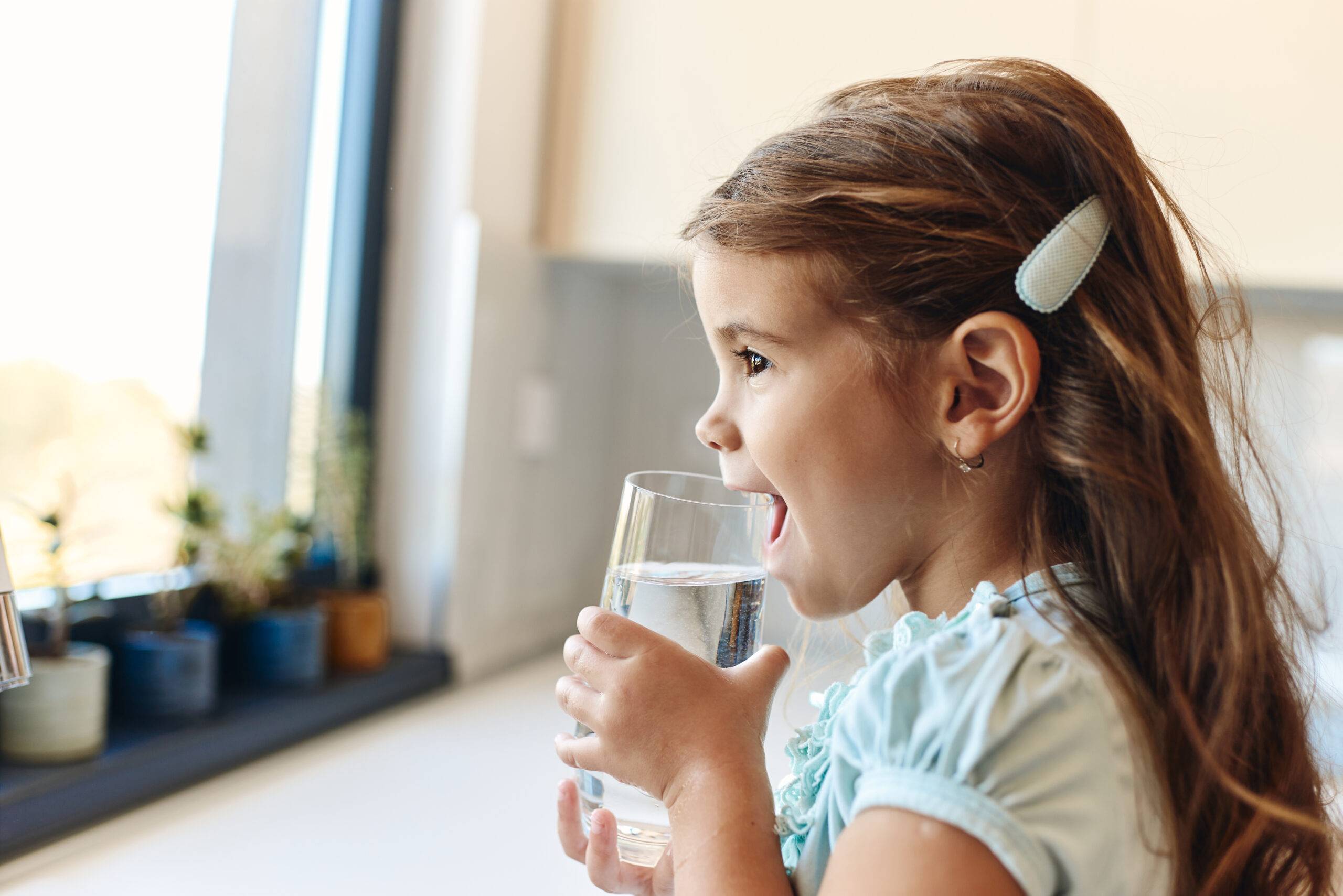 Beautiful girl drinking water